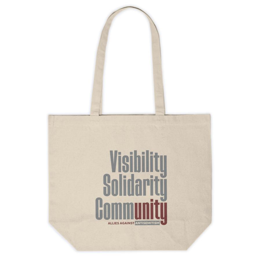 canvas tote bag with visibility solidarity community in orange, green, and burgundy block letters